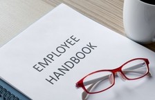 Employee handbook with reading glasses