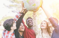 Group of teenagers holding globe