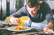 Professional Chef preparing dish in kitchen