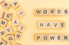 Wooden blocks spelling out the phrase 'words have power'