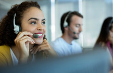 Close-up of a young woman wearing a headset and working in a call centre