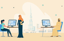 Illustration of people in an office with a backdrop of the Dubai skyline, one woman is wearing a hijab while the other is in front of her desktop computer, there is also a man wearing a thawb, sitting in front of his computer 