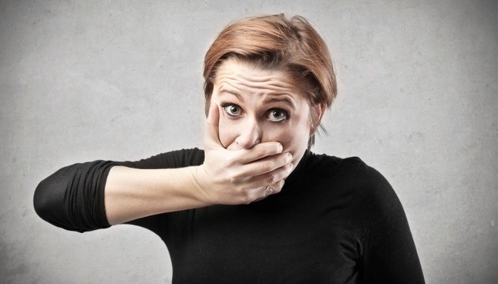 woman covering mouth