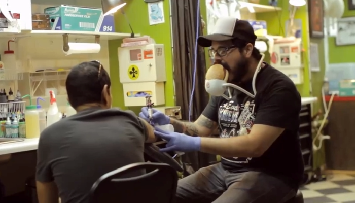 Tattoo artist eating burger