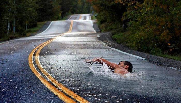 Man swimming in road