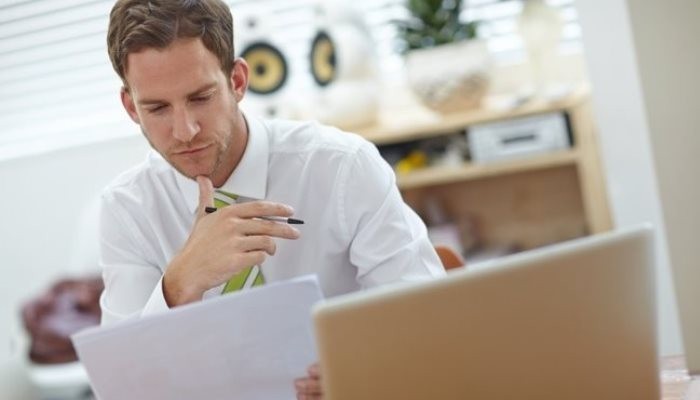 man looking at a paper