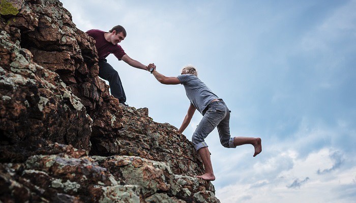 Helping a man climb to top