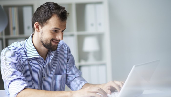 man typing on computer