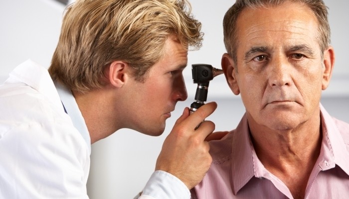 Audiologist examining patient