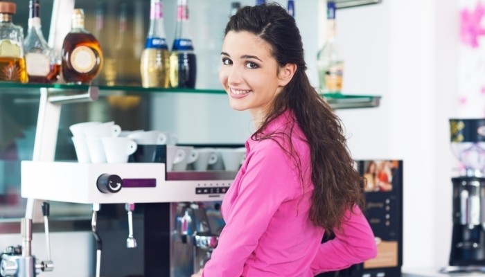 female barista making coffee