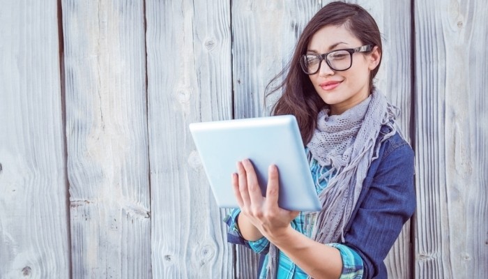 Smiling young woman with tablet