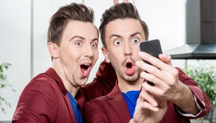 Twin brothers taking a selfie