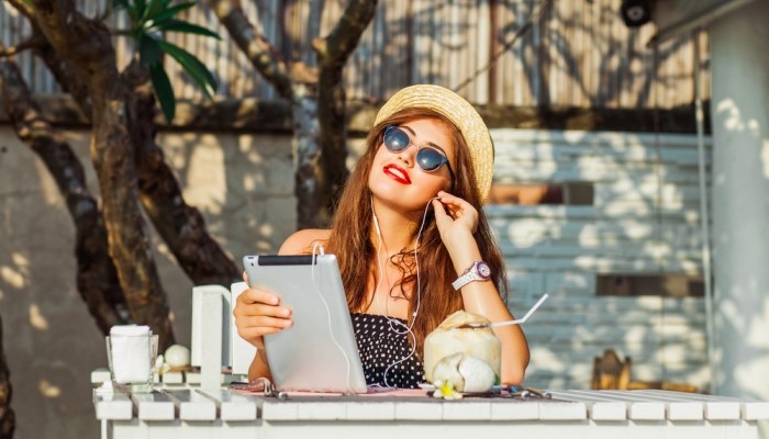 Smiling young woman with tablet