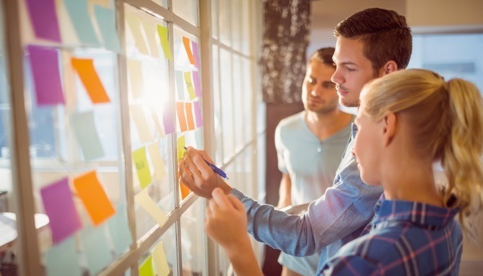 people at work using sticky notes