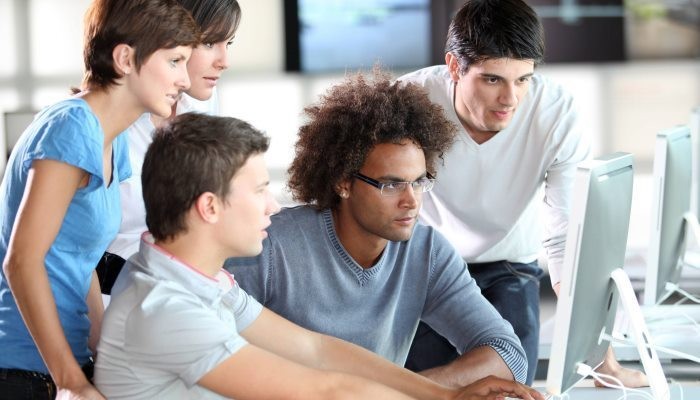 coworkers looking at the same computer screen