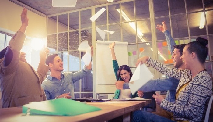 employees throwing paper