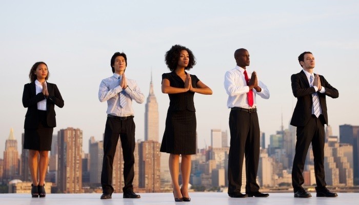 Business people practising yoga