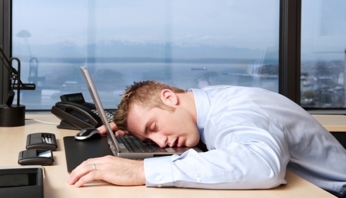 Businessman sleeping on laptop