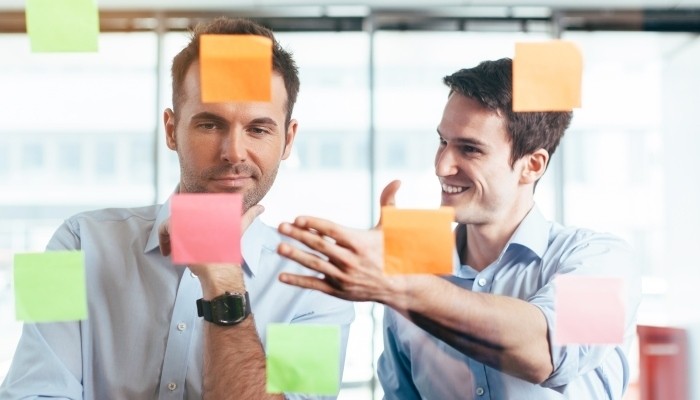 Businessman discussing plans with sticky notes