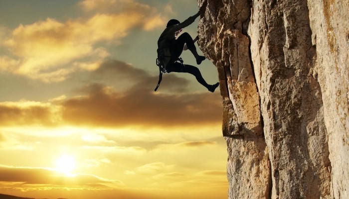 Silhouette rock climbing