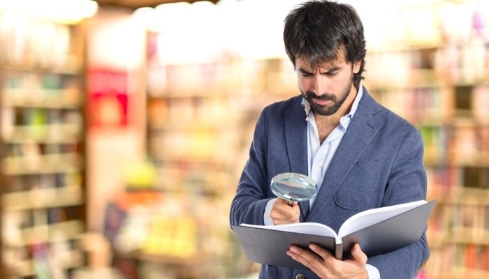 Man reading with magnifying glass