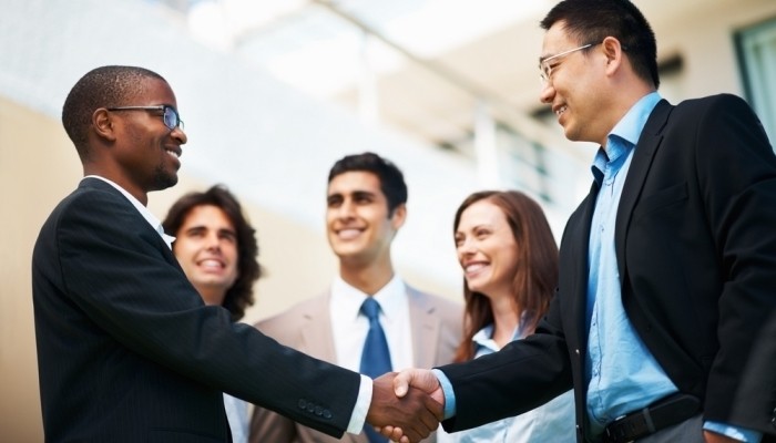 Businessmen networking and shaking hands