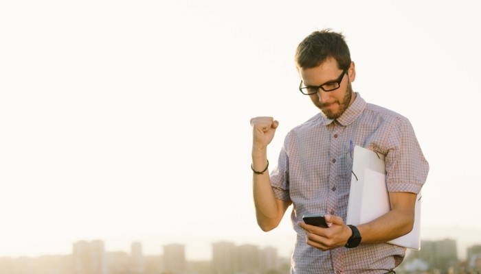 proud man looking at phone