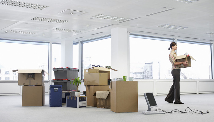 Woman carrying box in new office