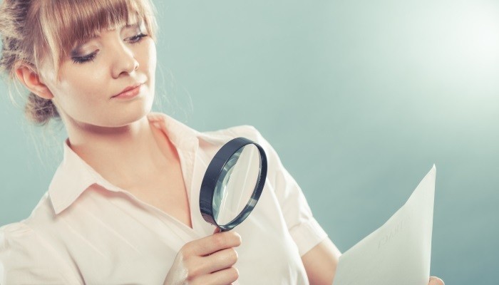 Woman with magnifying glass