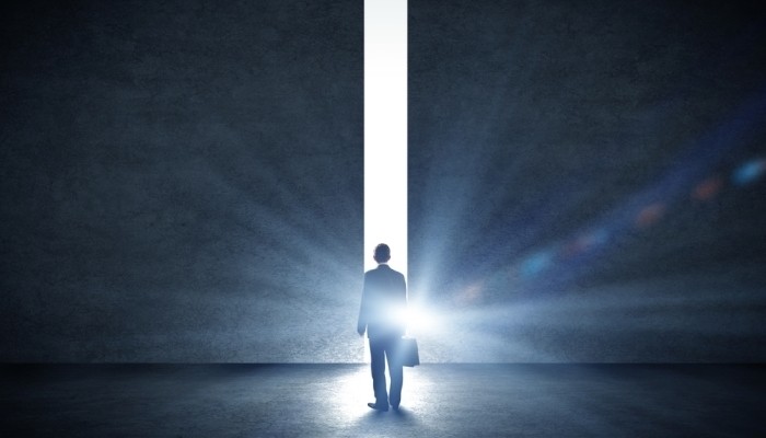 Businessman walking toward light