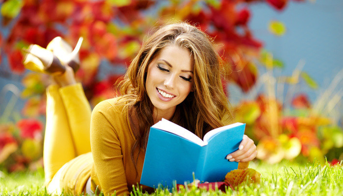 Smiling woman reading book