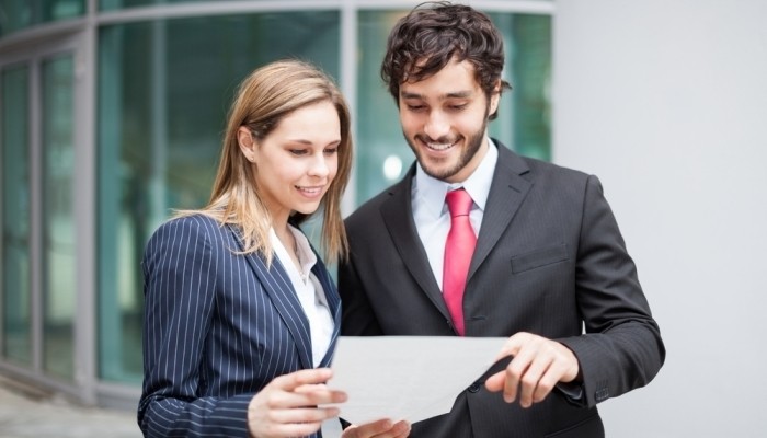 business people looking at paper
