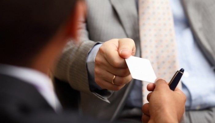 man gives business card