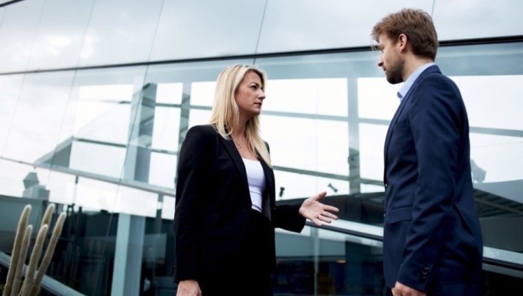 attractive businesswoman talking to man