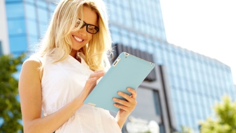 woman looking at tablet