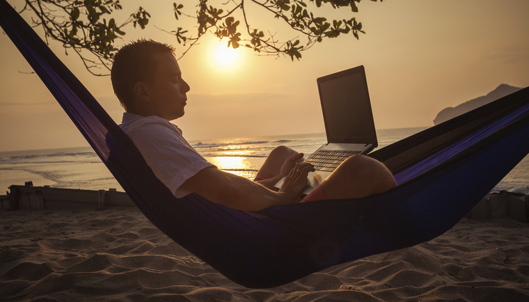 Man in hammock using laptop