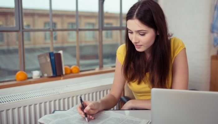 Young woman reading job ads