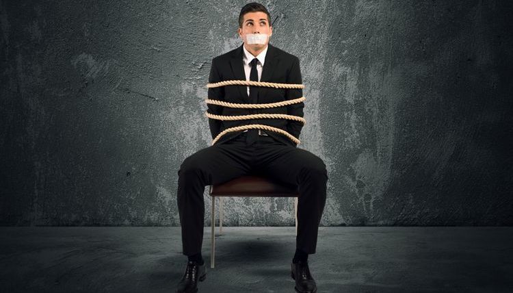 Businessman tied to chair