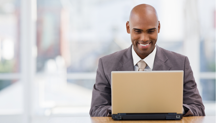 Man smiling at laptop