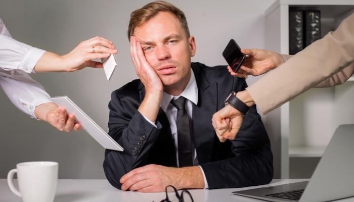 Tired man being overloaded at work