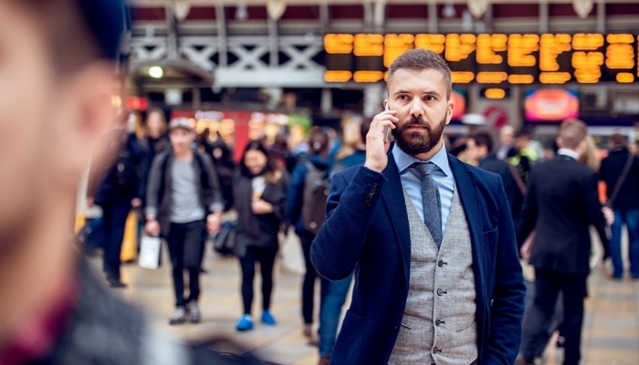 Busy businessman with smartphone, making phone call