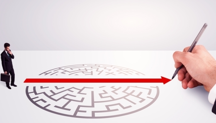 solution for successful businessman standing near the entrance of labyrinth