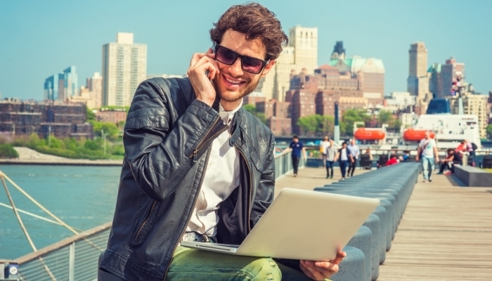 man with laptop working outside