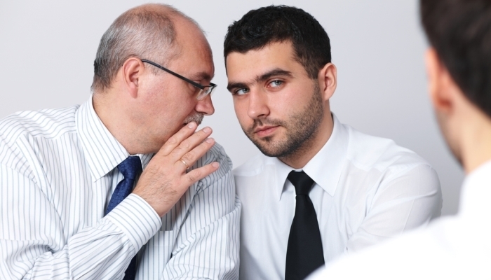 businessmen telling secrets