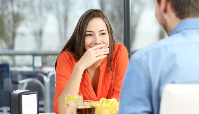 woman covering her mouth