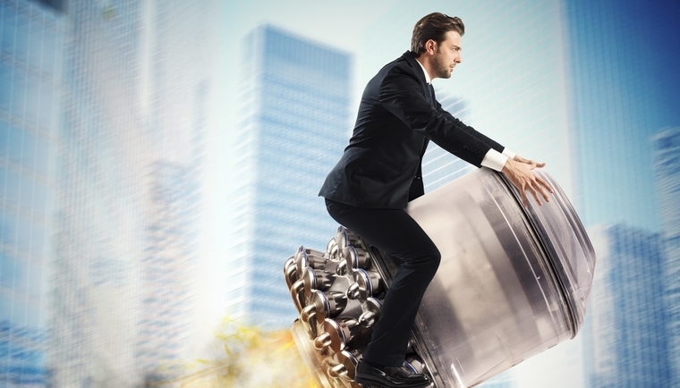 Businessman flying on rocket in city