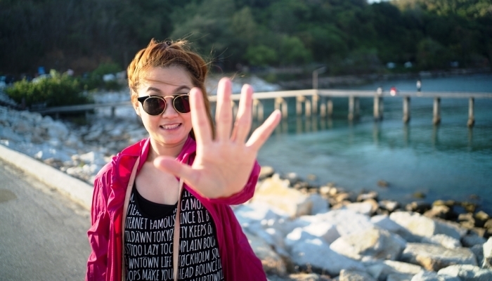 Happy woman hand sign say no