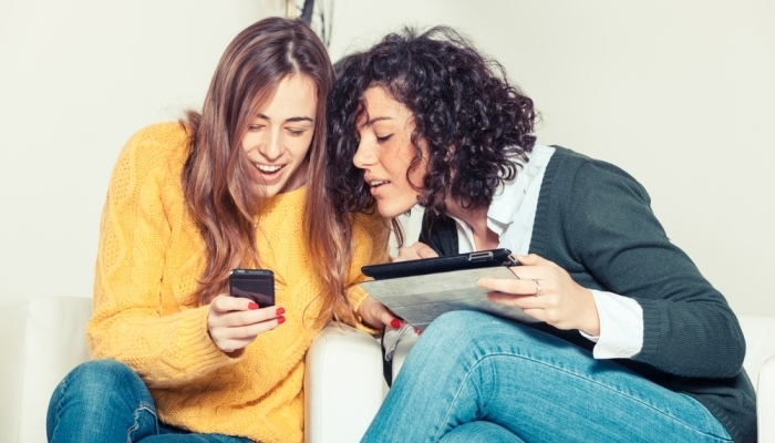 two women using technology