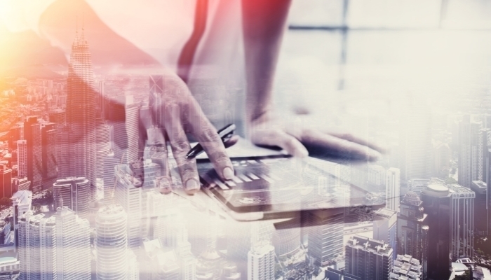 female hand touching tablet skyscraper background