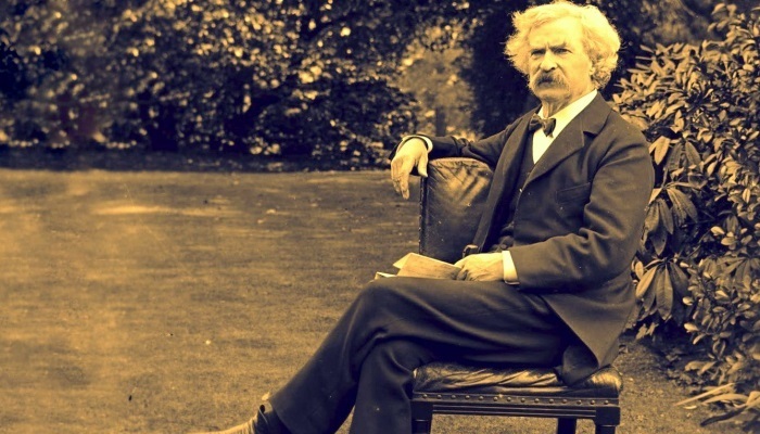 mark twain sitting on a chair